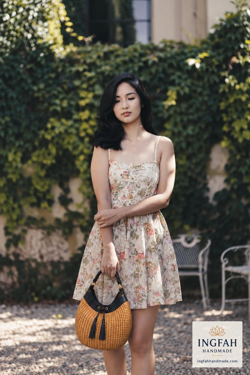 A woman in a floral sundress holding The Tide Hobo by its handle