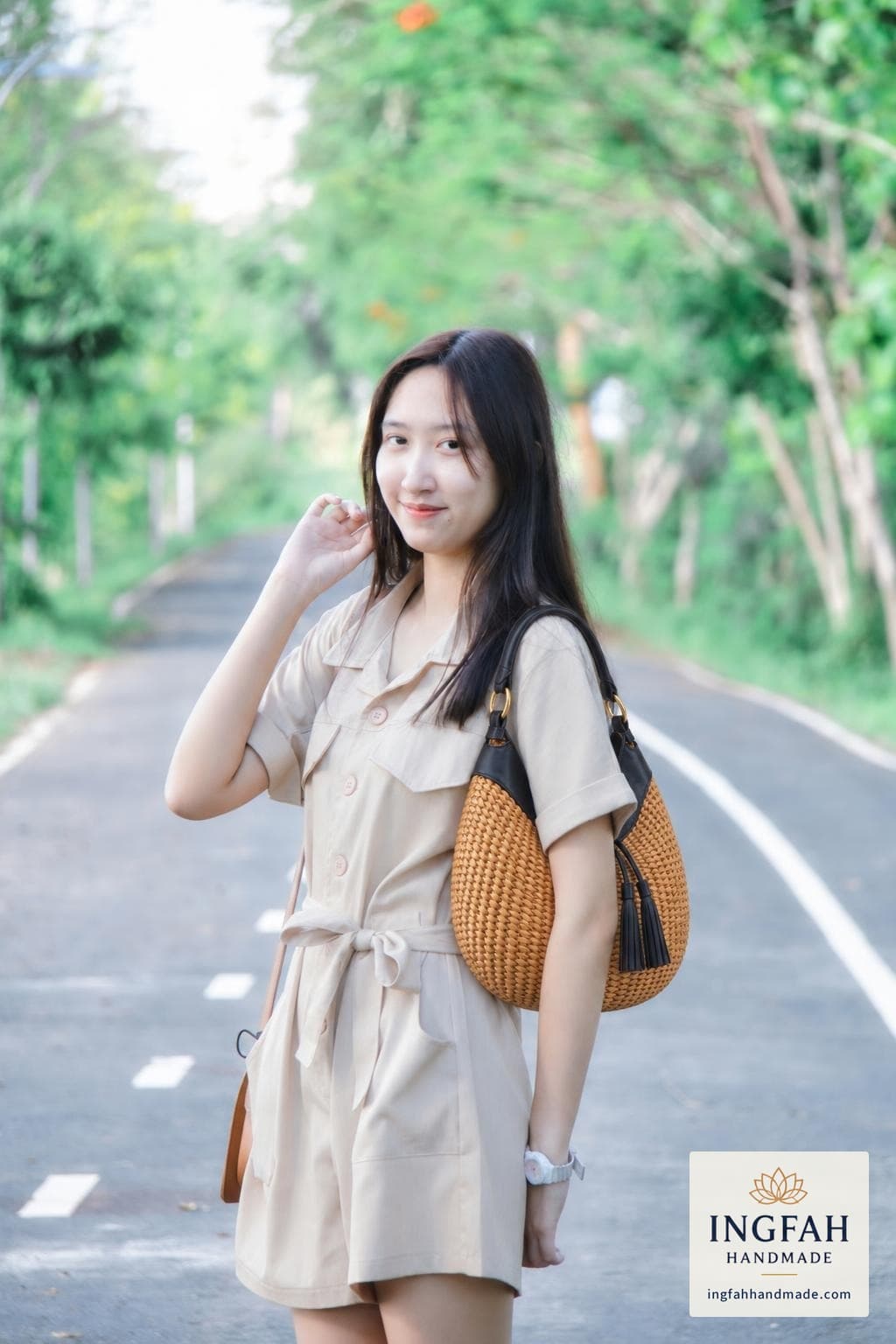 A woman in a beige playsuit with The Tide Hobo on her shoulder